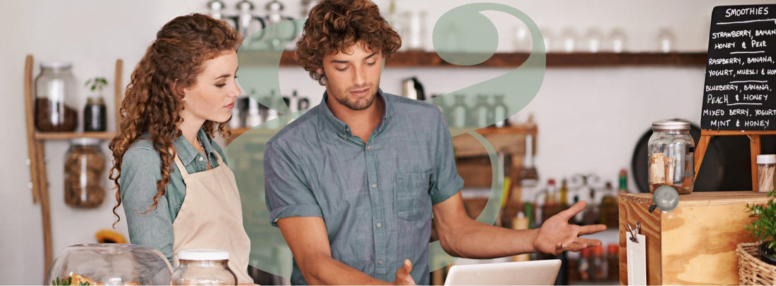 Small business owner working on brand identity with color palette, logo sketches, and laptop